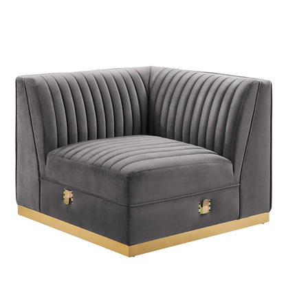 Gray velvet corner chair with vertical channel tufting, square arms, and gold base trim.