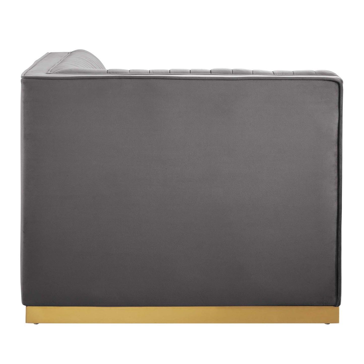 Grey upholstered armchair with low-profile rectangular silhouette and gold metal base.