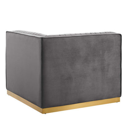Gray velvet boxy armchair with gold-tone metal base and stitched top edge.