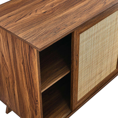 Walnut sideboard with open left shelf & woven rattan door on the right; tapered legs.