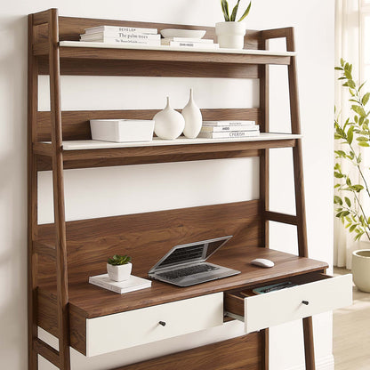 White desk with drawers and open shelving; laptop on the desk, a potted plant and books on the shelves.