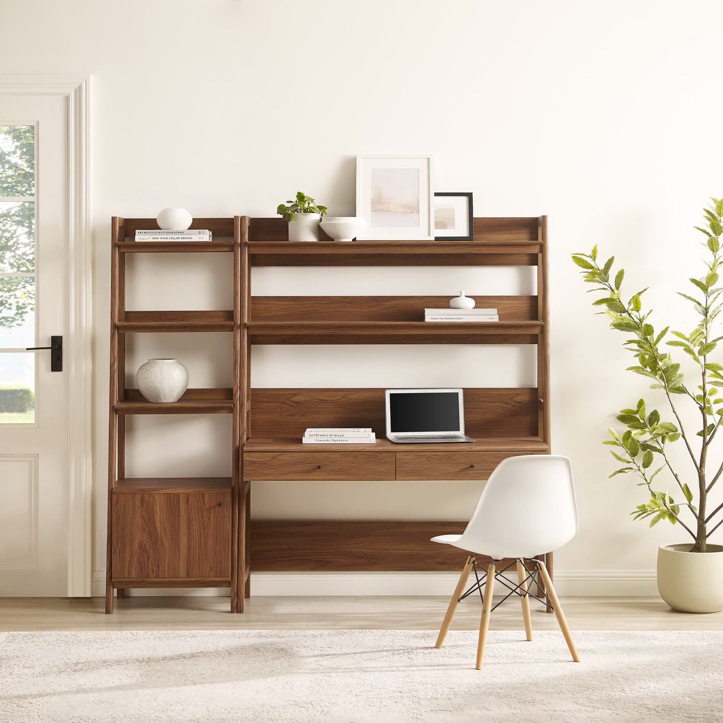 Walnut wood office desk and bookshelf two-piece set with open shelves and drawers, white chair in a bright living room.