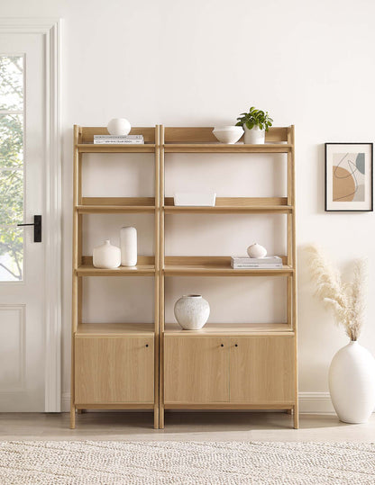 Pair of oak open-shelf bookcases with bottom cabinets, decorated with vases, bowls, books and a plant in a bright room