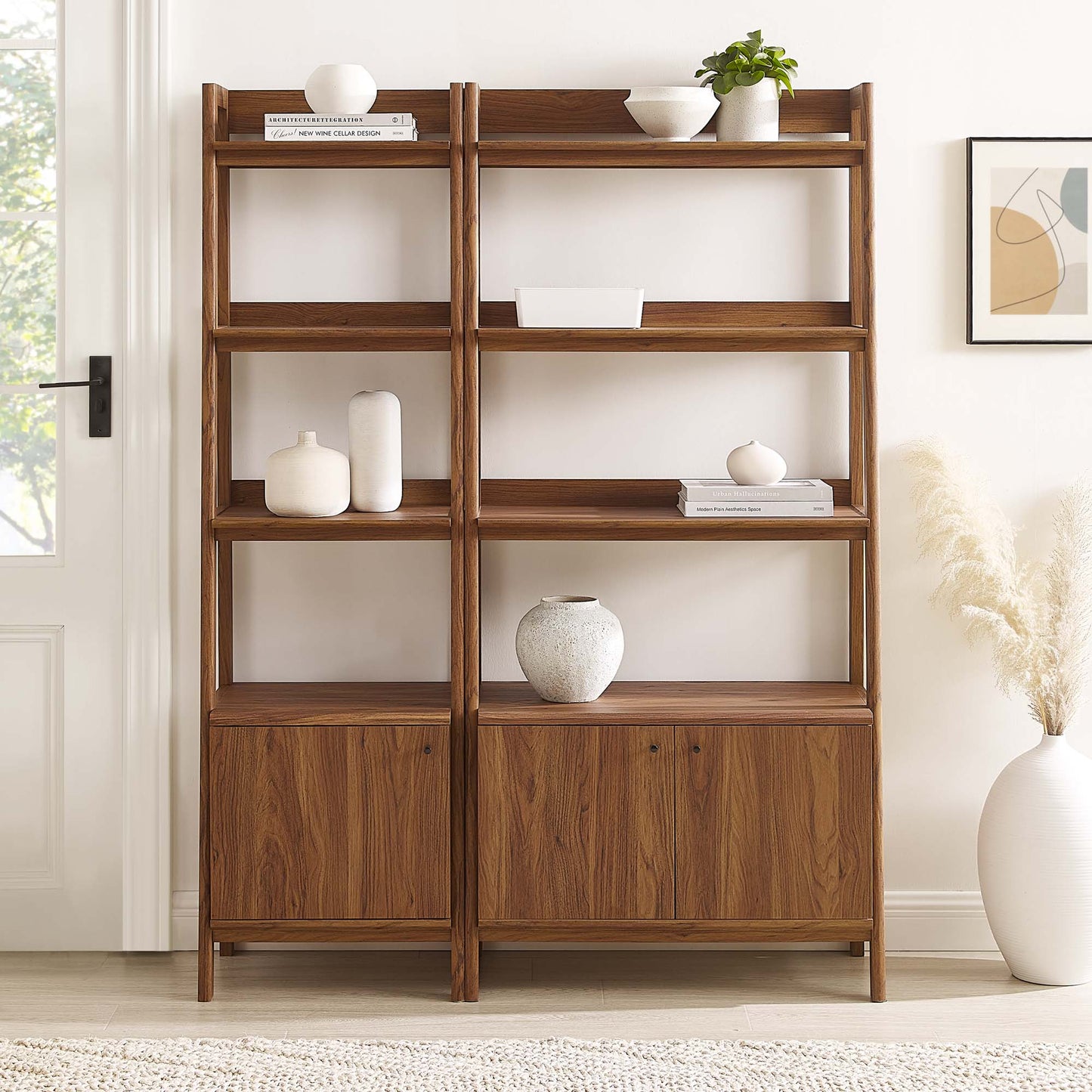 Walnut wood bookshelves, set of 2, with two vertical sections, open shelves above and two cabinet doors below, mid-century modern style.