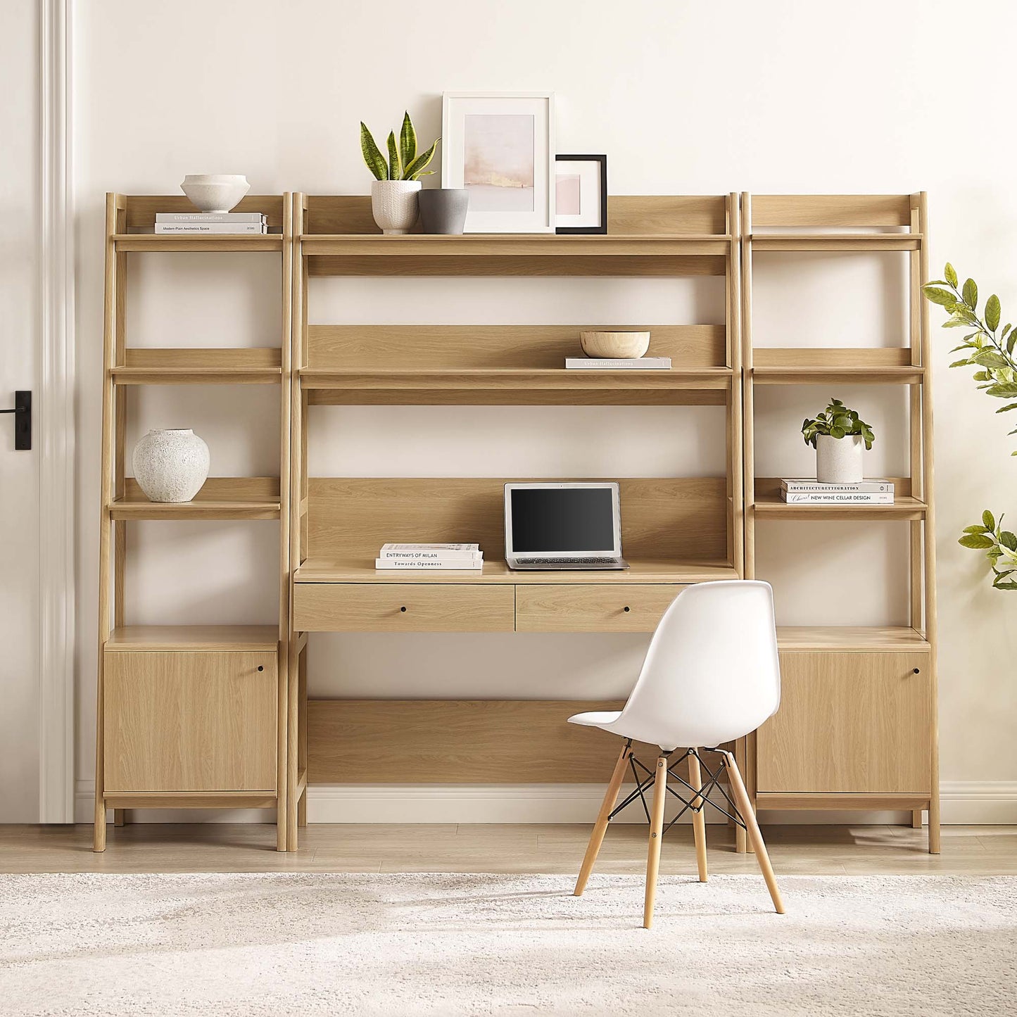 Brown oak wood 3-piece office desk and bookshelf with open shelves and drawers, and a mid-century chair, in a minimal home office.
