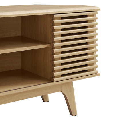 Natural oak wood corner TV stand with slatted door and open shelves, angled legs.