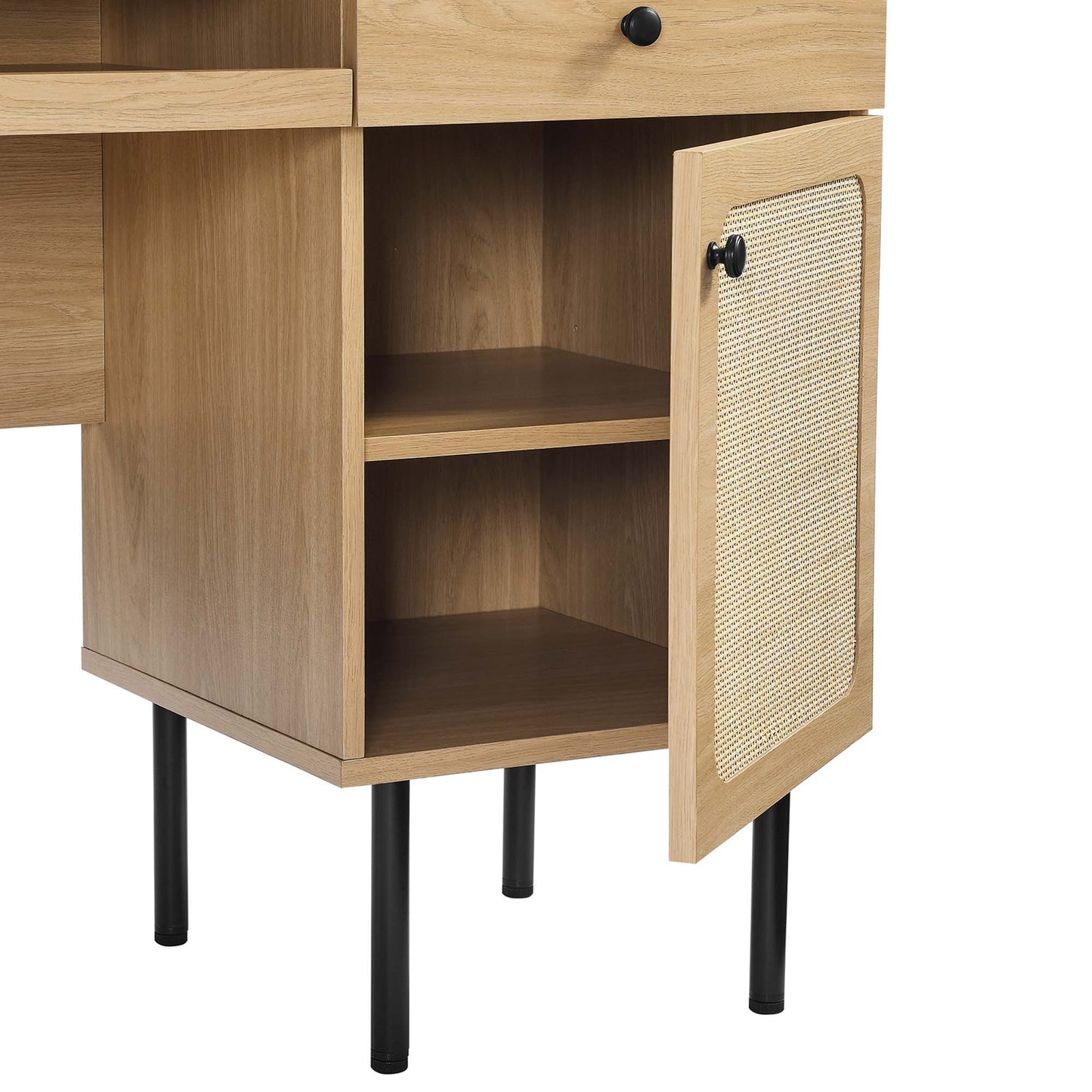 Oak wood desk with a top drawer, right-side cabinet door with a woven rattan panel, two internal shelves, and black metal legs.