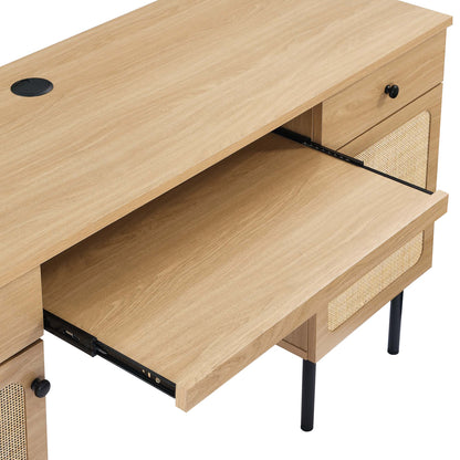 Brown oak desk with cable grommet, pull-out drawer, cane-panel fronts, black knobs, and slim black legs.