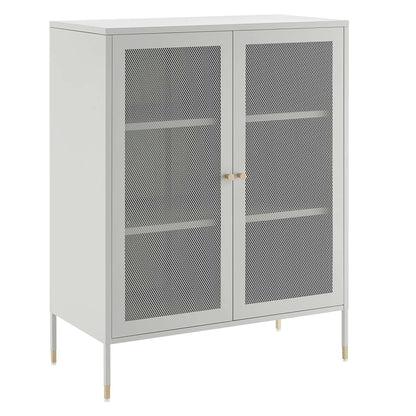 Light gray metal storage cabinet with two mesh doors, interior shelves, and slim legs with gold-tipped feet.