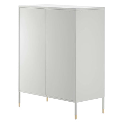 Light gray tall cabinet with two doors, minimalist modern storage on slim metal legs with gold caps.