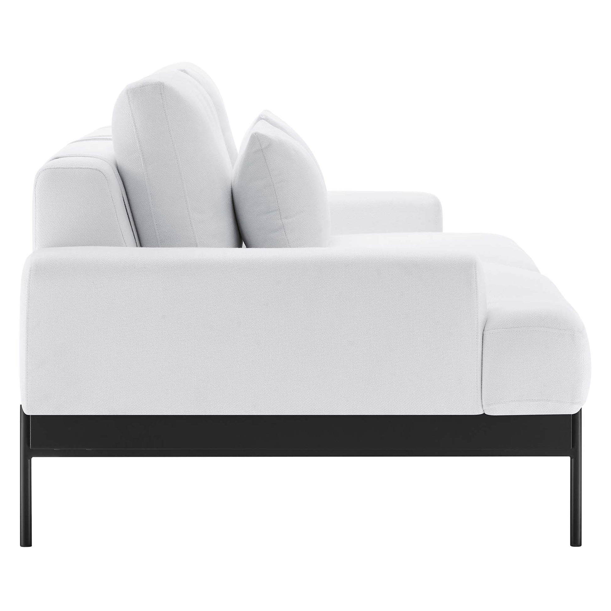 White fabric sofa with black metal legs and plush cushions, modern seating.