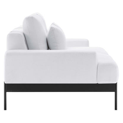 White fabric sofa with black metal legs and plush cushions, modern seating.