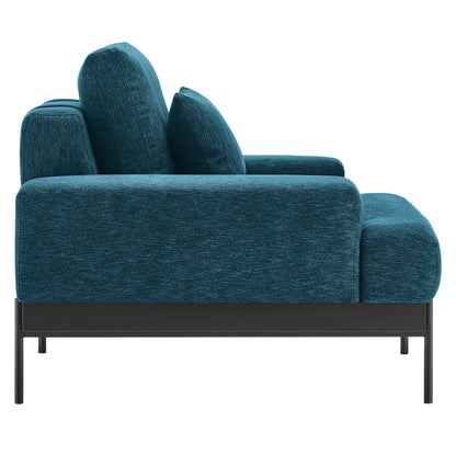 Teal blue fabric armchair with black metal legs and square cushions, contemporary low-profile design for living rooms.