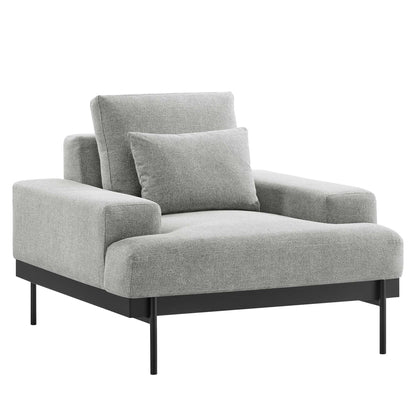 Grey upholstered fabric armchair with low black metal legs and a matching throw pillow.