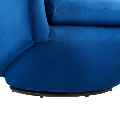 Navy blue velvet accent chair with rounded seat and black circular swivel base.