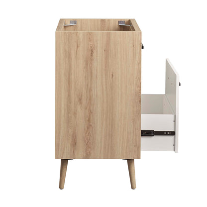 Oak veneer mid-century modern bathroom vanity cabinet with tapered legs and an open right-side drawer revealing a white interior.
