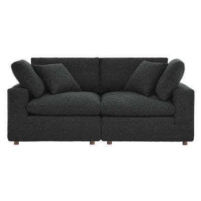 Charcoal gray boucle fabric loveseat with two-seat cushions, back cushions, square arms, wooden legs, and two throw pillows.