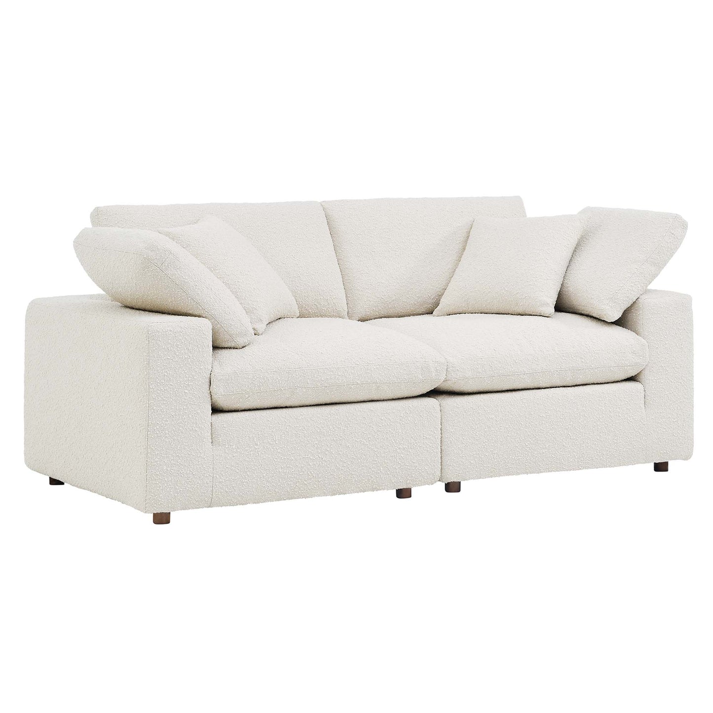 Ivory boucle fabric loveseat with plush cushions, square arms, two-seat layout and matching throw pillows.
