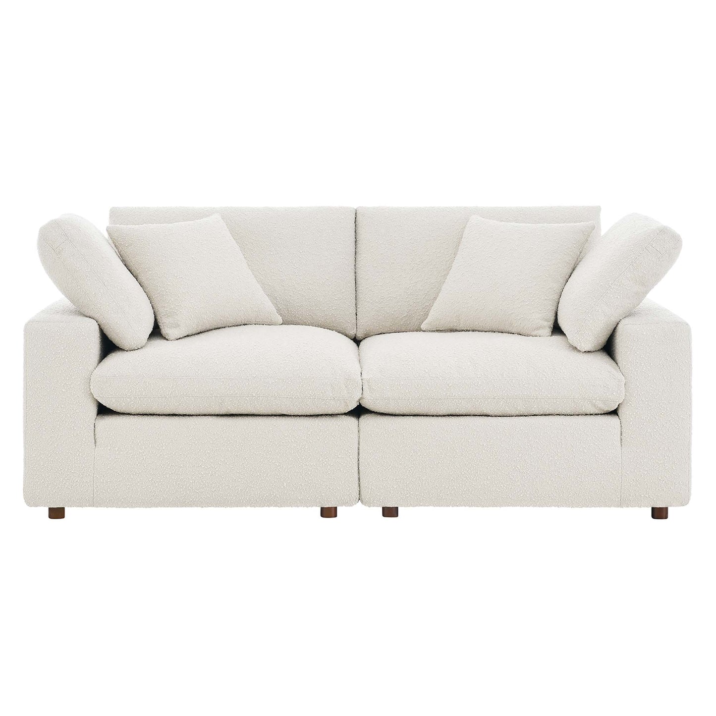 Ivory boucle fabric loveseat with straight square arms, two-seat cushions, two back cushions, and matching throw pillows.