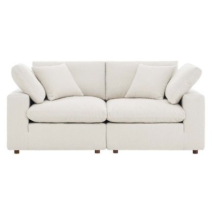 Ivory boucle fabric loveseat with straight square arms, two-seat cushions, two back cushions, and matching throw pillows.
