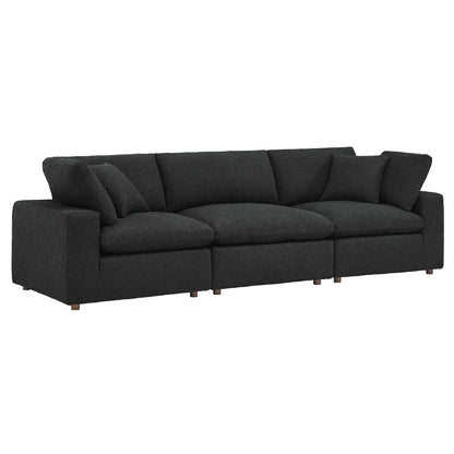 Black boucle fabric 3-Seater sofa with three seat cushions, matching back cushions, boxy arms and wooden legs.