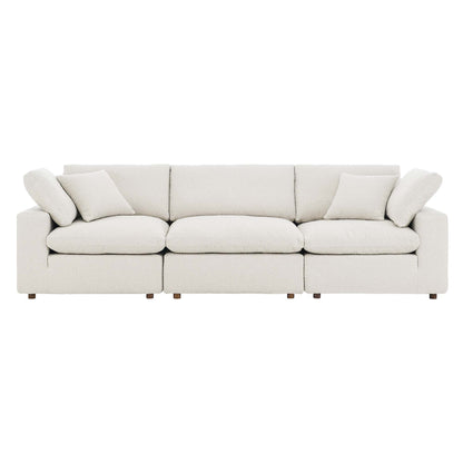Ivory boucle fabric 3-seater sofa with plush cushions, low arms and wooden legs.