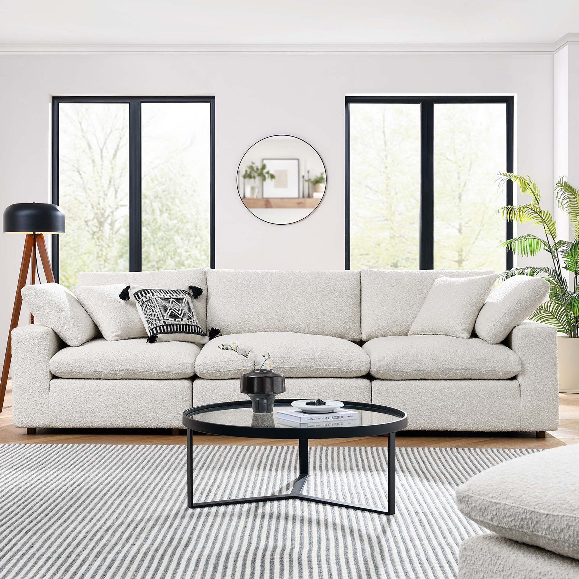 Ivory 3-Seater sofa with neutral pillows in a sunny living room; round coffee table, striped rug, circular mirror, windows.