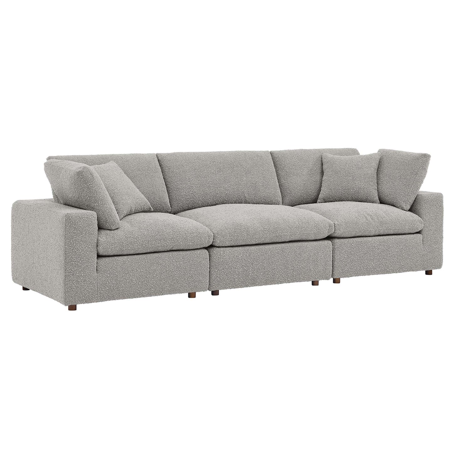Gray fabric sofa with square arms, three-seat cushions, multiple back cushions, short wooden legs.