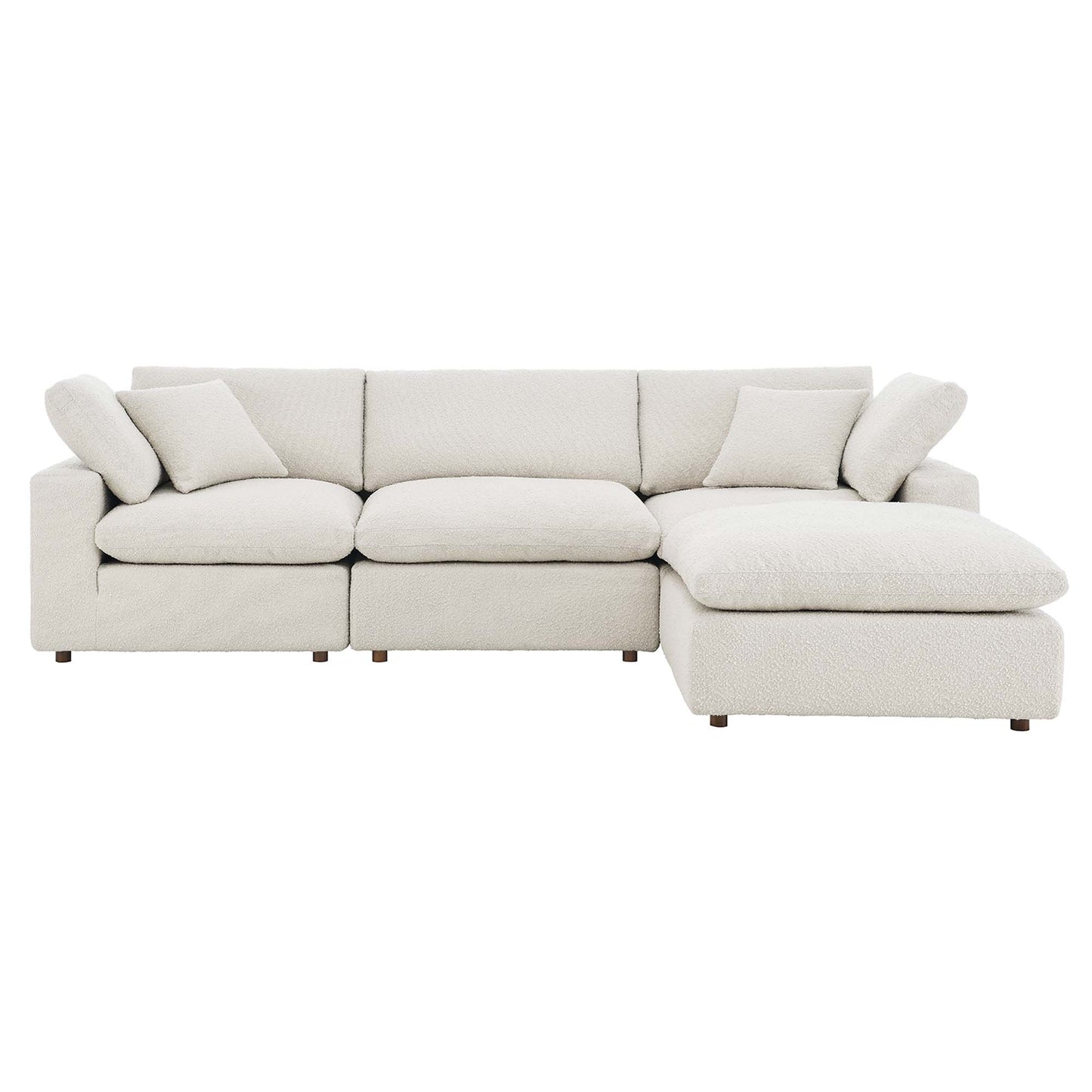 Ivory textured fabric sectional sofa with chaise, L-shaped, cushioned backrests and throw pillows, short wooden legs.