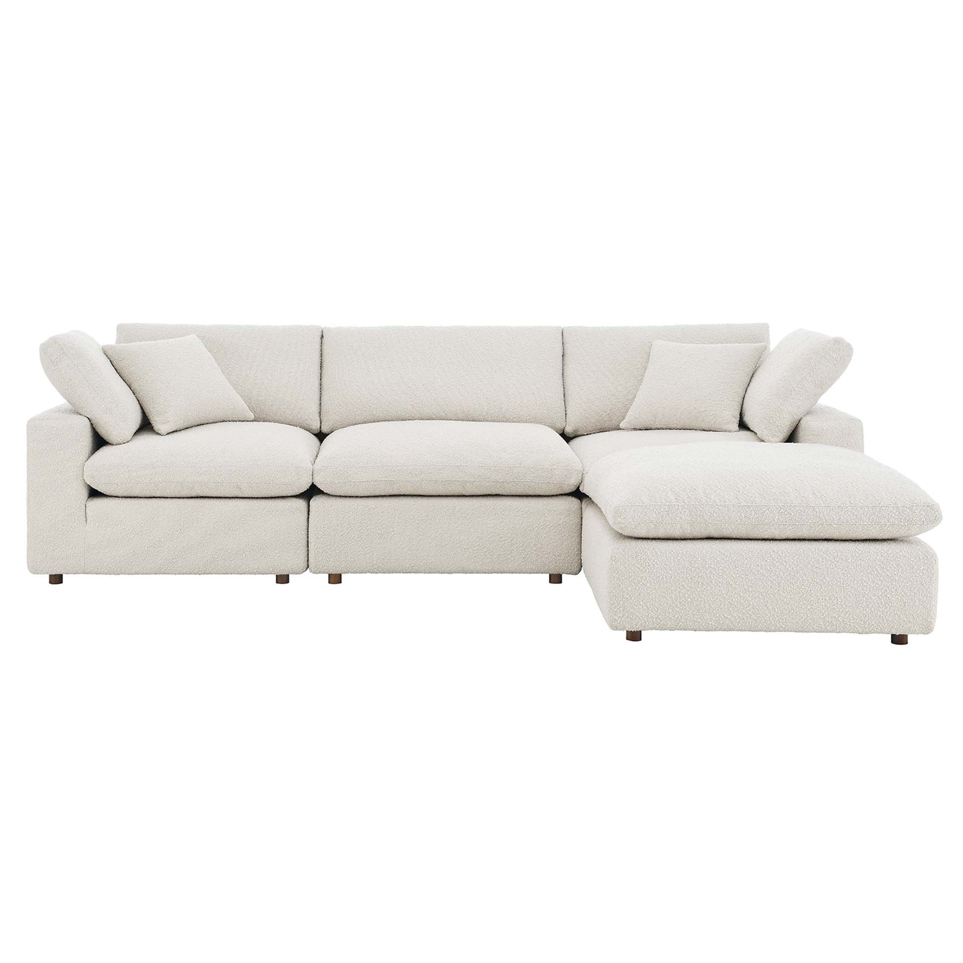 Ivory textured fabric sectional sofa with chaise, L-shaped, cushioned backrests and throw pillows, short wooden legs.