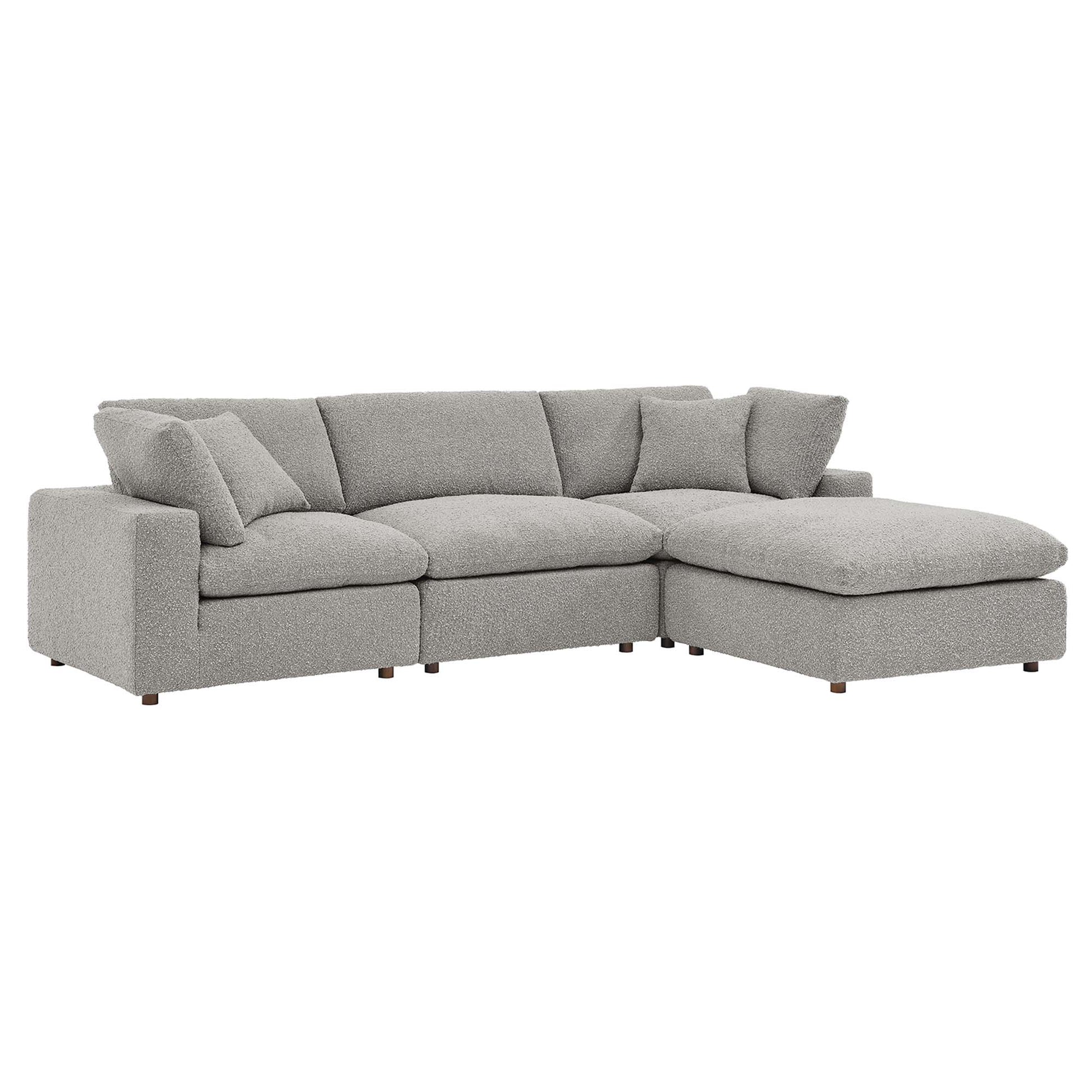 Grey fabric L-shaped sectional sofa with right-side chaise, plush cushions, modern low-profile wooden legs.