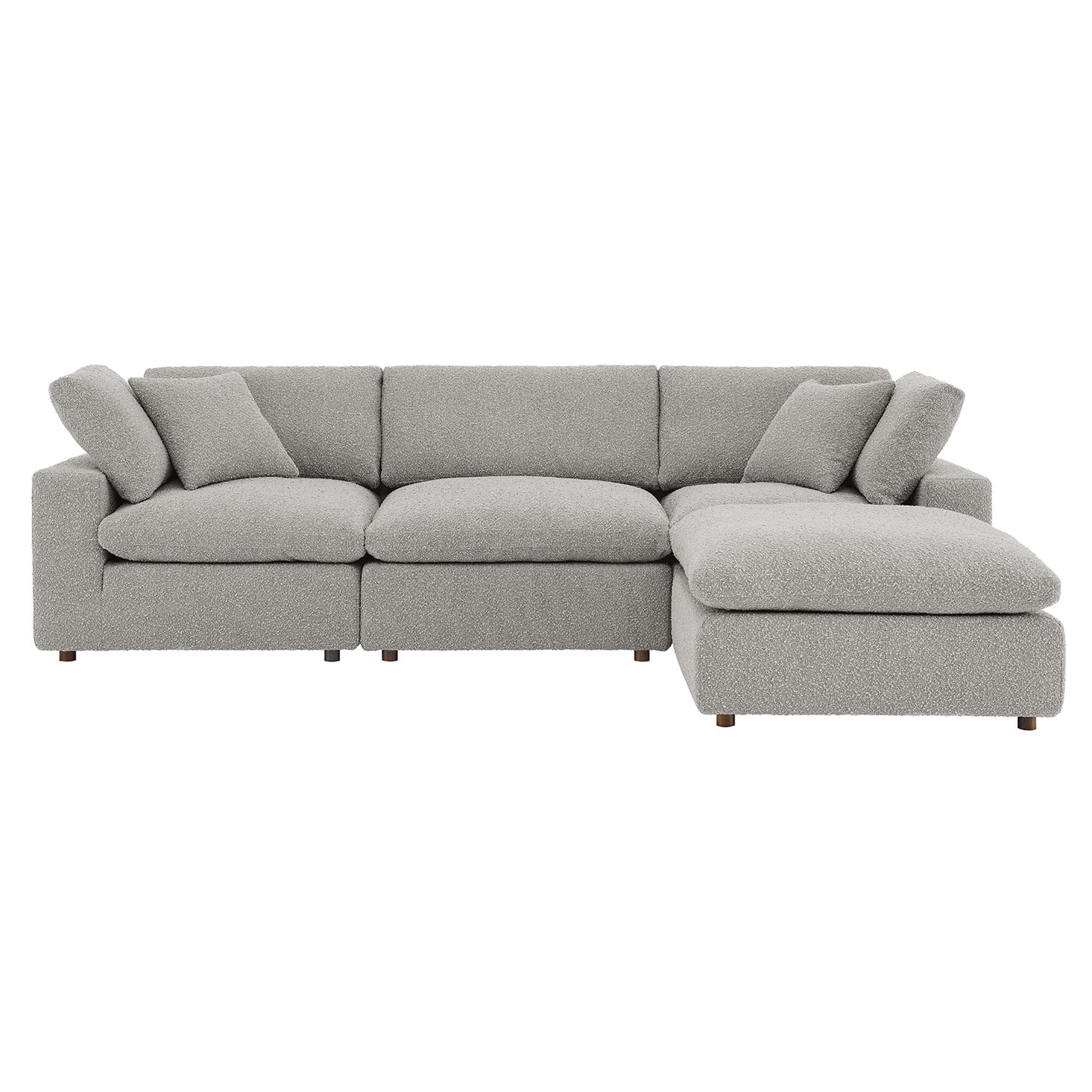Light gray fabric sectional sofa with right-side chaise, cushioned back, and square cushions on modern low legs.