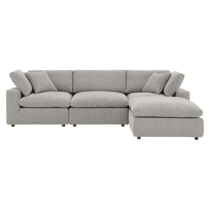 Light gray fabric sectional sofa with right-side chaise, cushioned back, and square cushions on modern low legs.