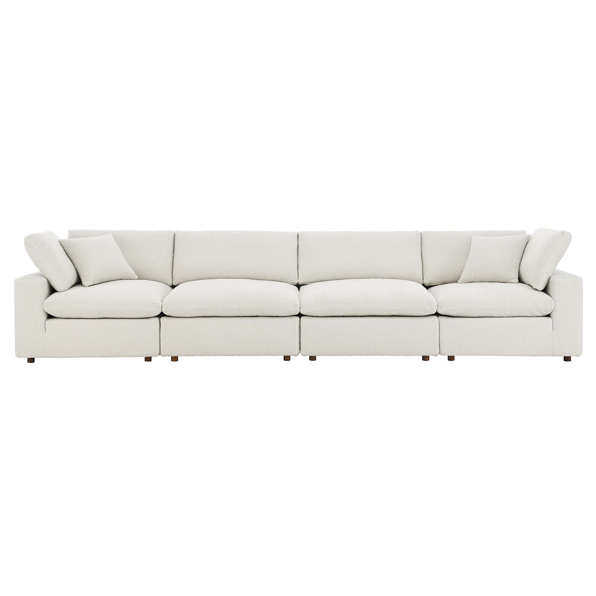 Ivory boucle fabric sofa with low-profile arms, four seat cushions, plush back cushions and short wooden feet.