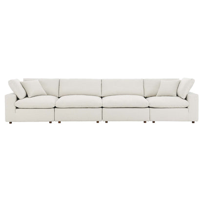 Ivory boucle fabric sofa with low-profile arms, four seat cushions, plush back cushions and short wooden feet.