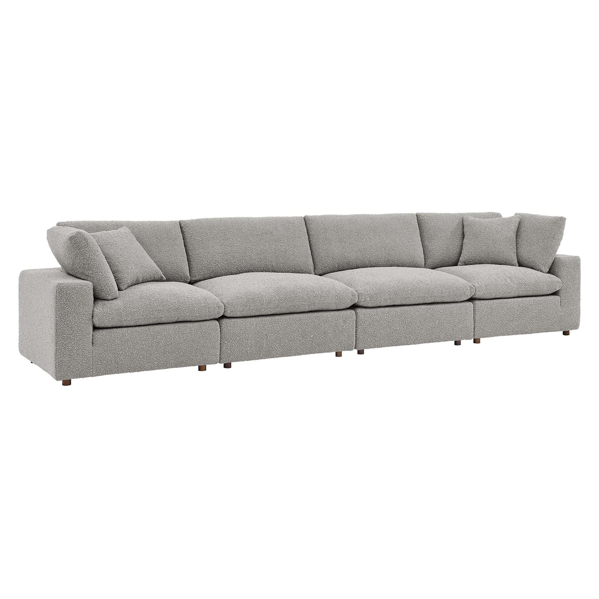 Light gray boucle fabric 4-Seater sofa with loose back cushions and wooden legs.