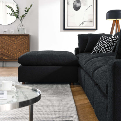 Charcoal fabric sectional sofa with chaise in a modern living room, with patterned pillows and glass coffee table.