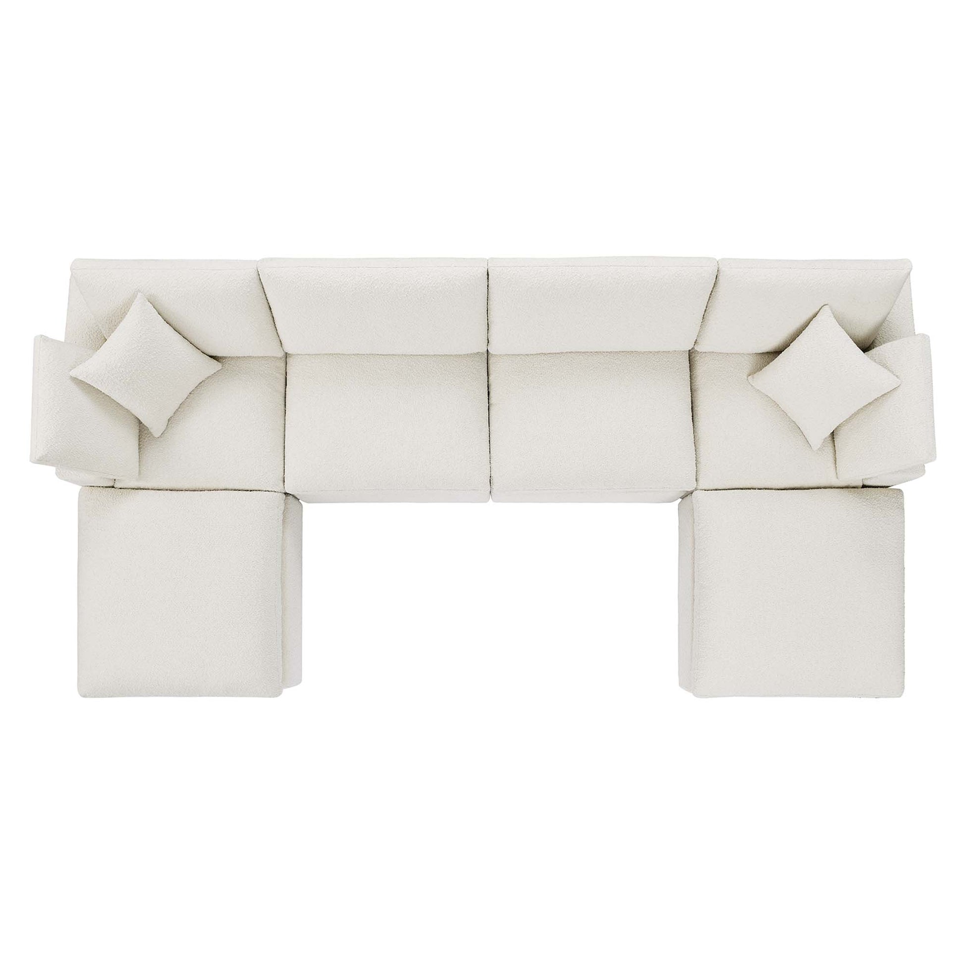 Cream ivory fabric modular sectional with matching throw pillows and ottomans, contemporary lounge.