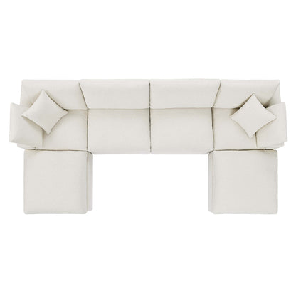 Cream ivory fabric modular sectional with matching throw pillows and ottomans, contemporary lounge.