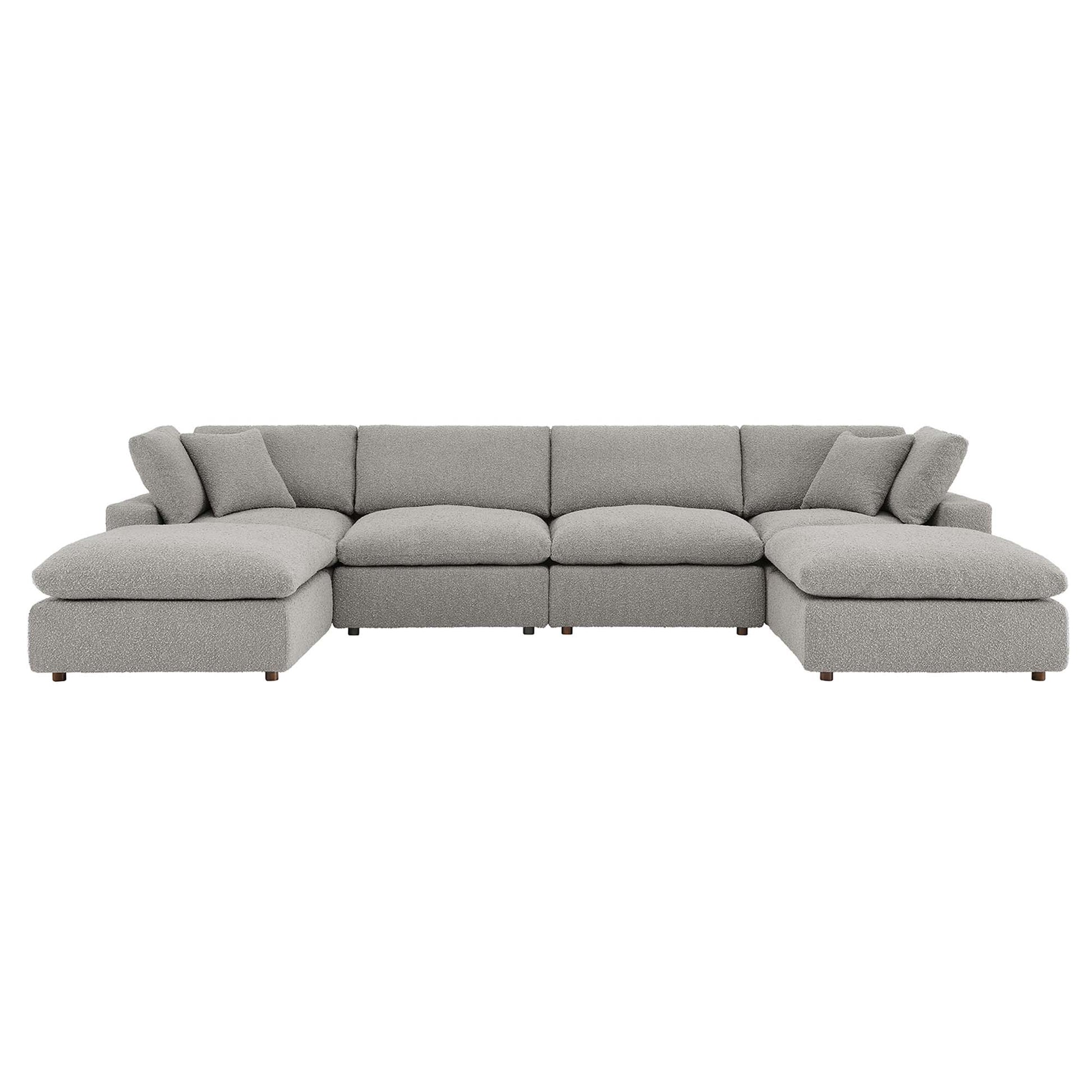 Gray fabric sectional sofa with long central seat and end chaises, plush back cushions and pillows.