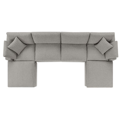 Light gray fabric modular sectional sofa with square cushions and matching ottomans for modern living room seating.