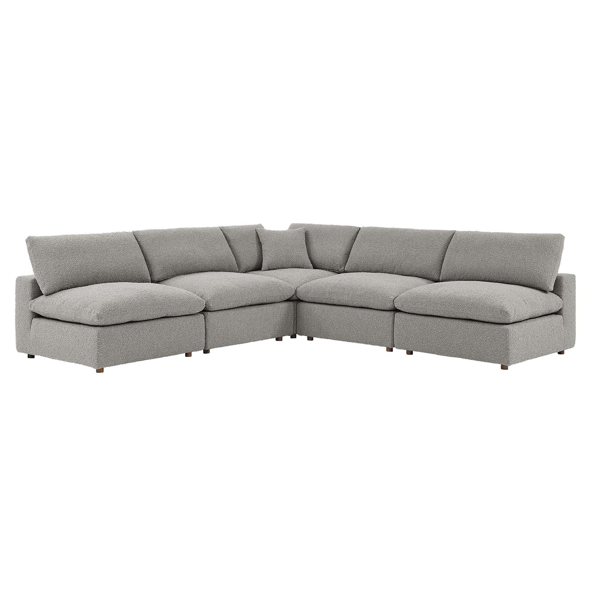 Light gray fabric L-shaped sectional sofa with plush cushions and low wooden legs.