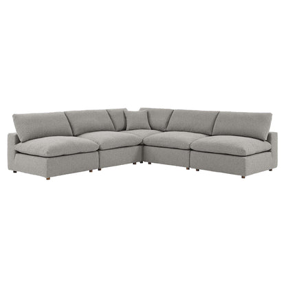 Light gray fabric L-shaped sectional sofa with plush cushions and low wooden legs.