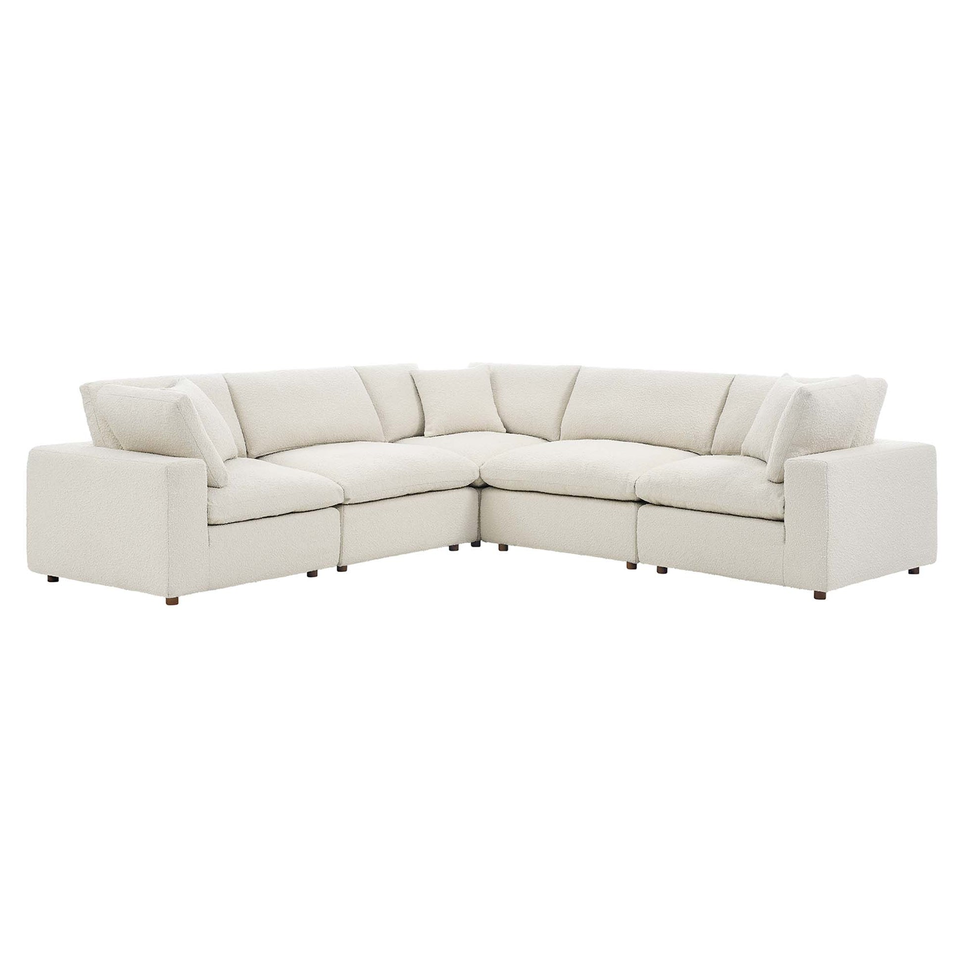 Ivory fabric sectional sofa, L-shaped with plush cushions and low arms, contemporary living room seating.