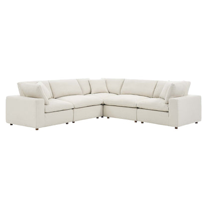 Ivory fabric sectional sofa, L-shaped with plush cushions and low arms, contemporary living room seating.