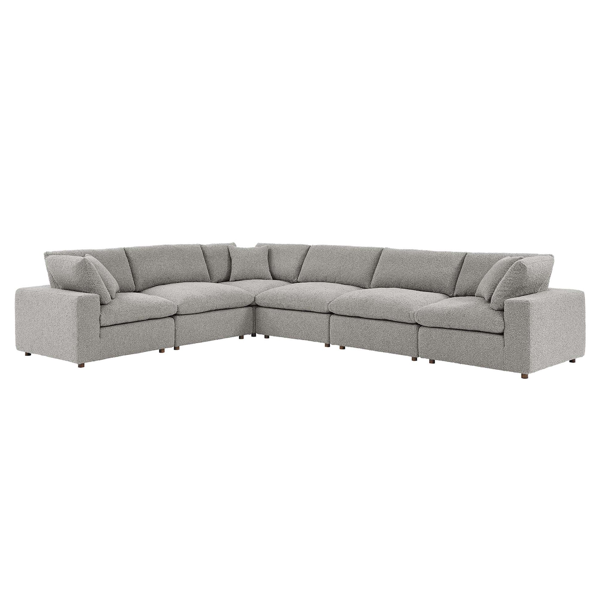 Light gray fabric L-shaped sectional sofa with plush back cushions and tapered wooden legs.