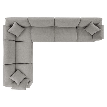 Gray fabric modular L-shaped corner sectional sofa with square throw pillows.