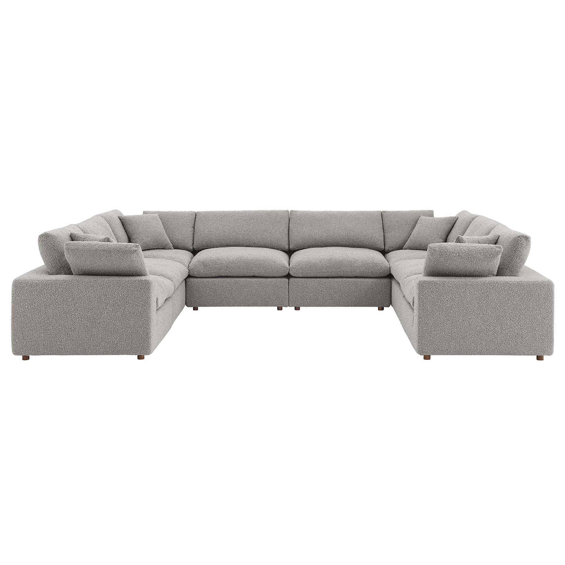Light gray fabric modular sectional sofa with square arms, plush cushions and low wooden legs.