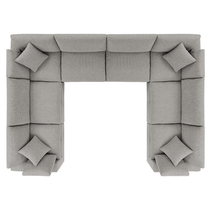 Light gray fabric modular sectional sofa in a U-shaped layout with square cushions and matching pillows.