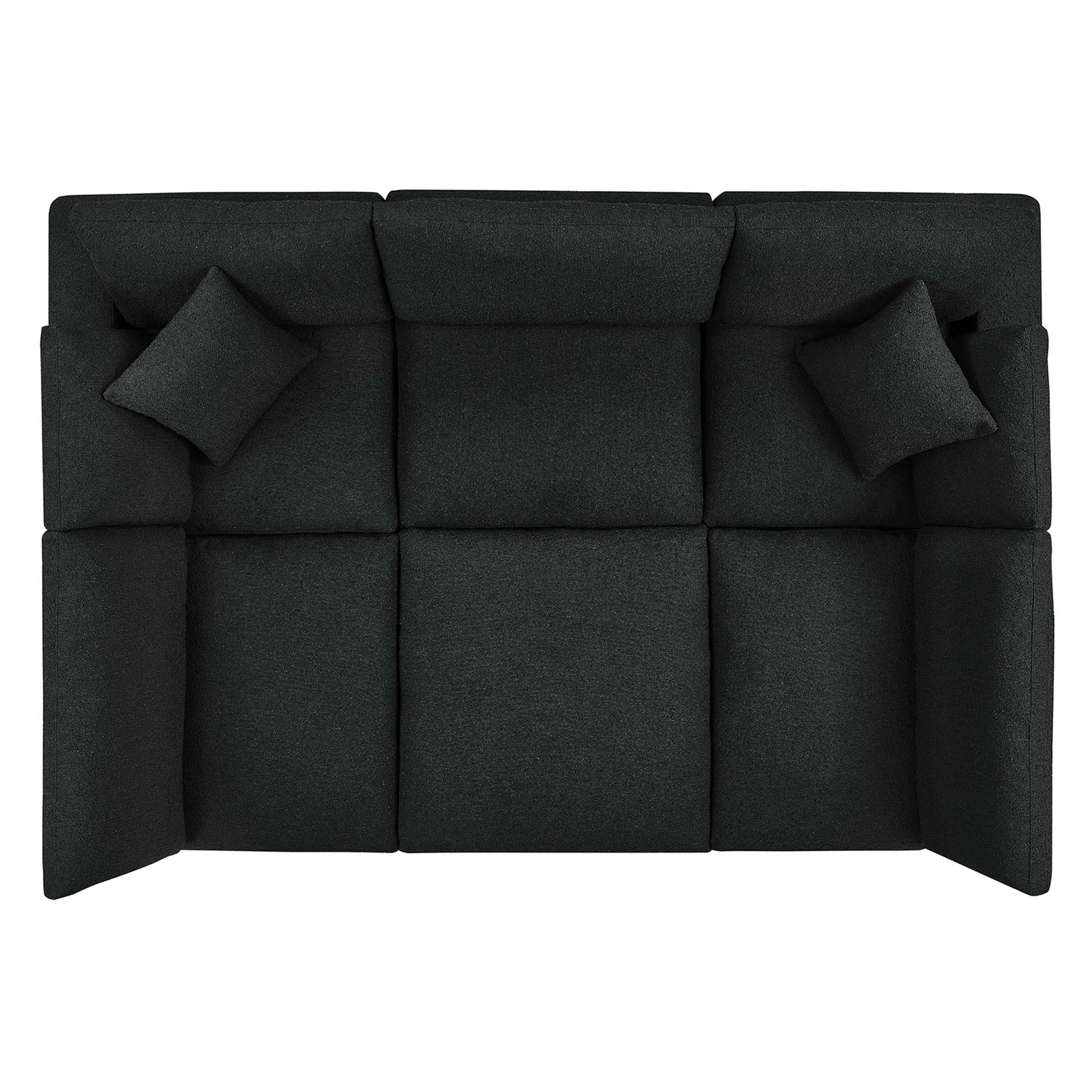 Dark charcoal boucle fabric sectional sofa with square tufted cushions and two matching throw pillows.